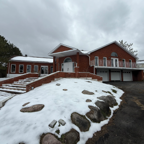 Front view of house with 3 car garage and large driveway