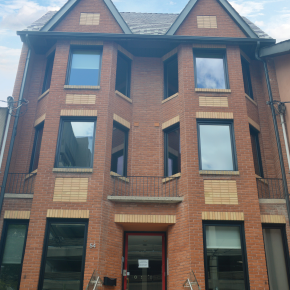Photo of 3 story office building with red brick