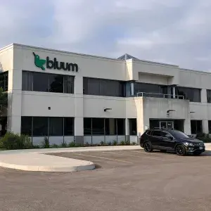 Photo of white precast industrial building with office on two floors 