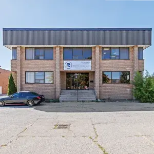 7669 Kimbel Street front view of two storey brick building with parking in front 