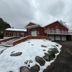 Front view of house with 3 car garage and large driveway