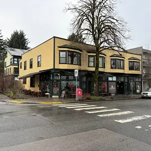 2 storey mixed use commercial building with yellow and black brick at corner stop sign intersection