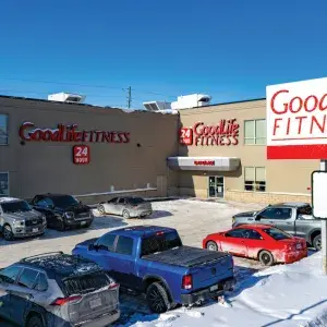 Outside entrance and parking lot of Good Life Fitness building