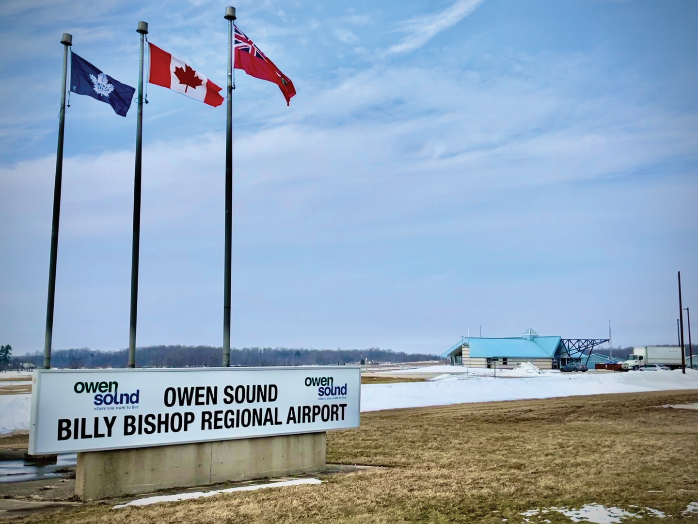 Owen Sound Airport sign and flags