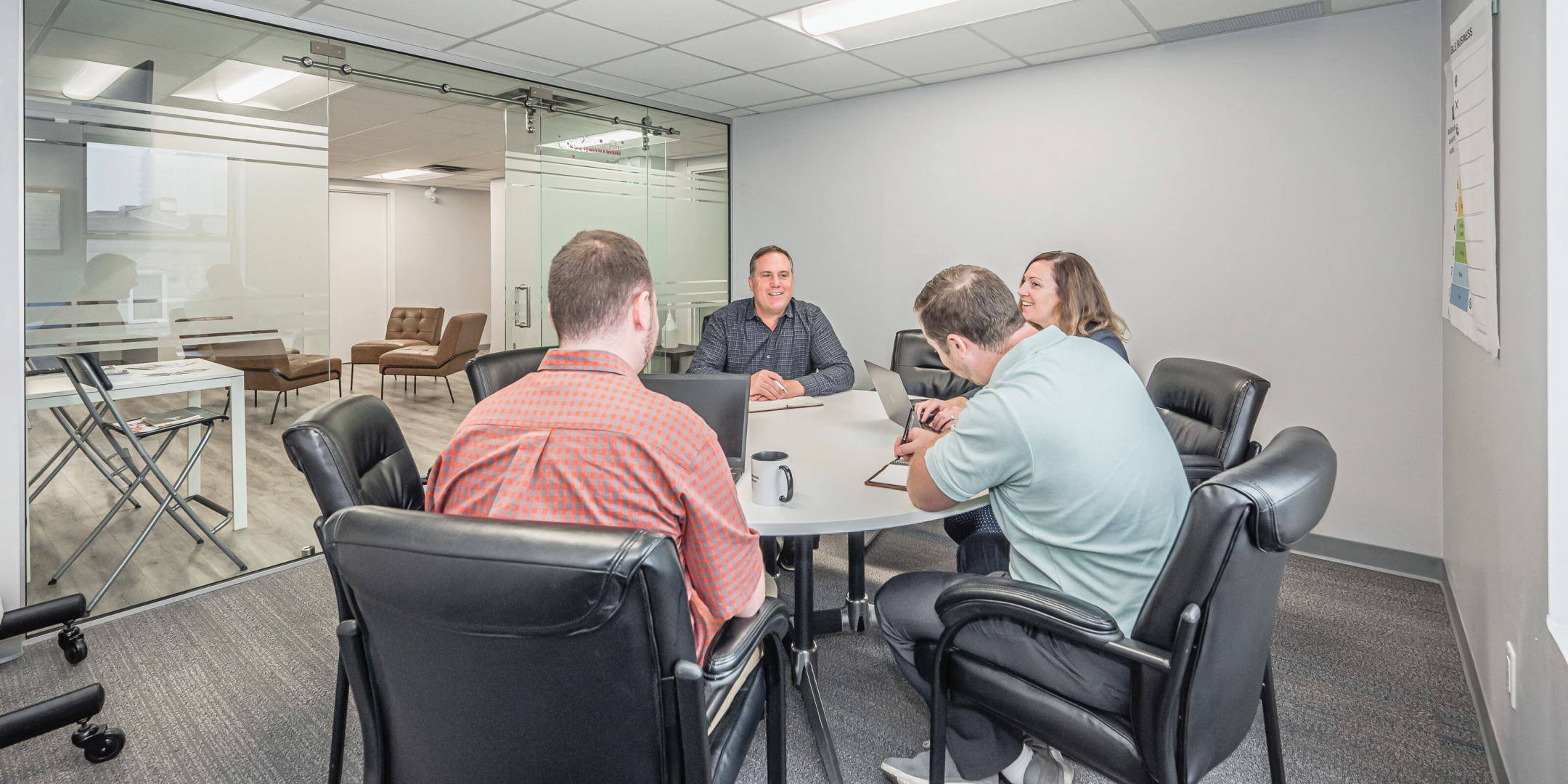 People sitting around a meeting table in a room