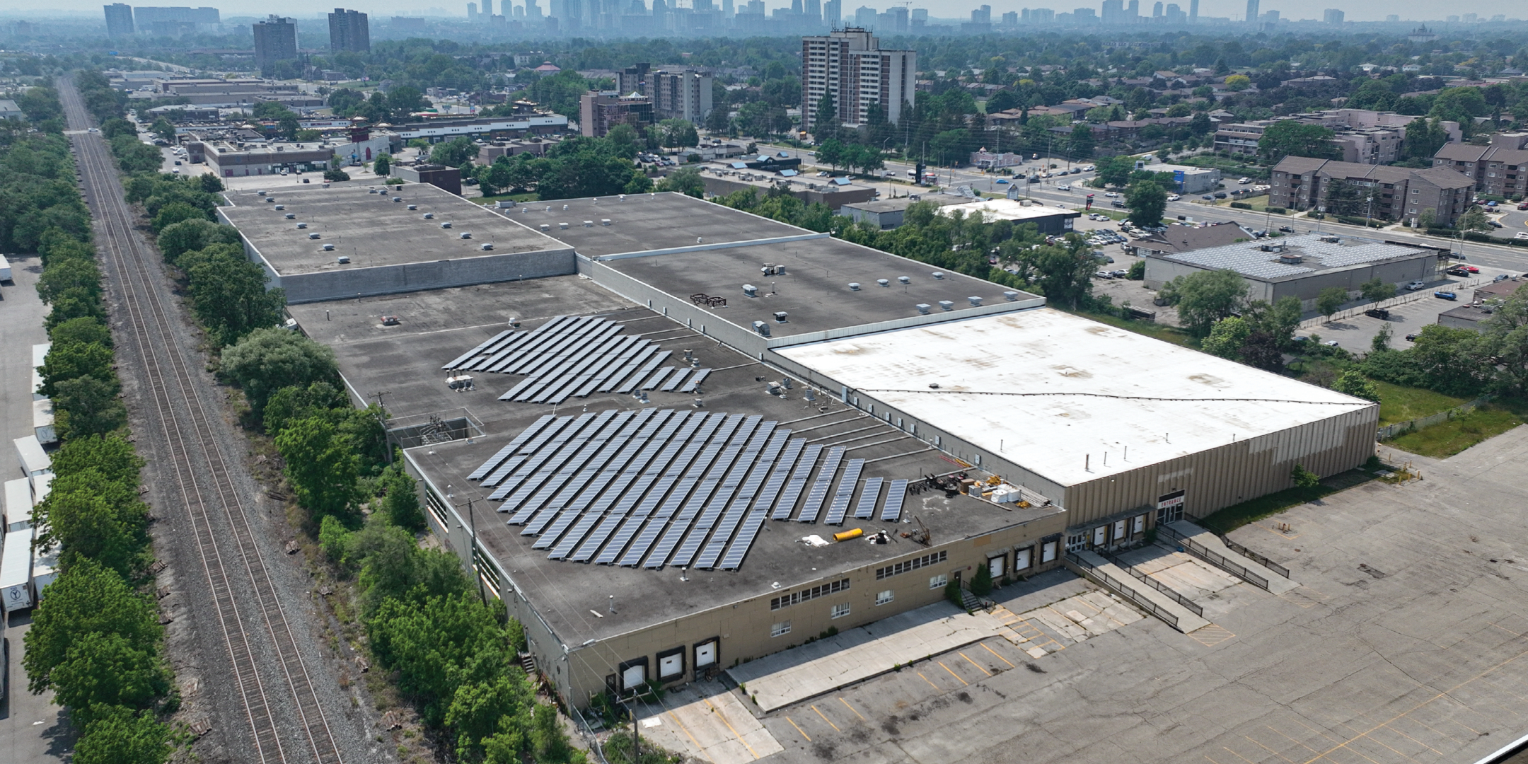 Aerial of 2550 Stanfield Road showing main entrance, shipping doors, and railroad