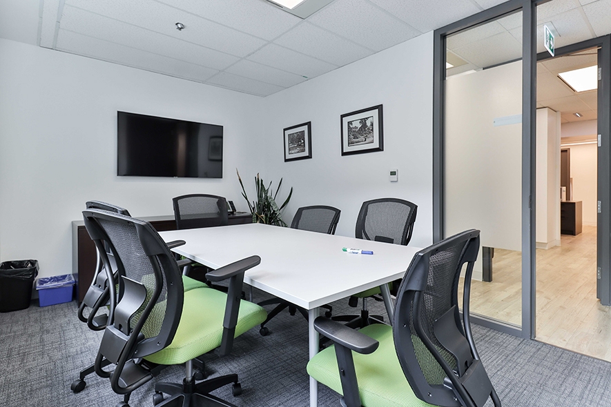 55 York Street boardroom with desk & chairs and TV mounted on the wall
