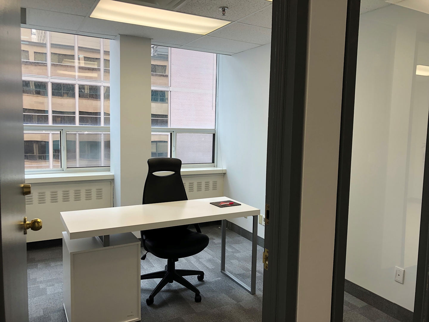 133 Richmond St W interior view of small office with big windows