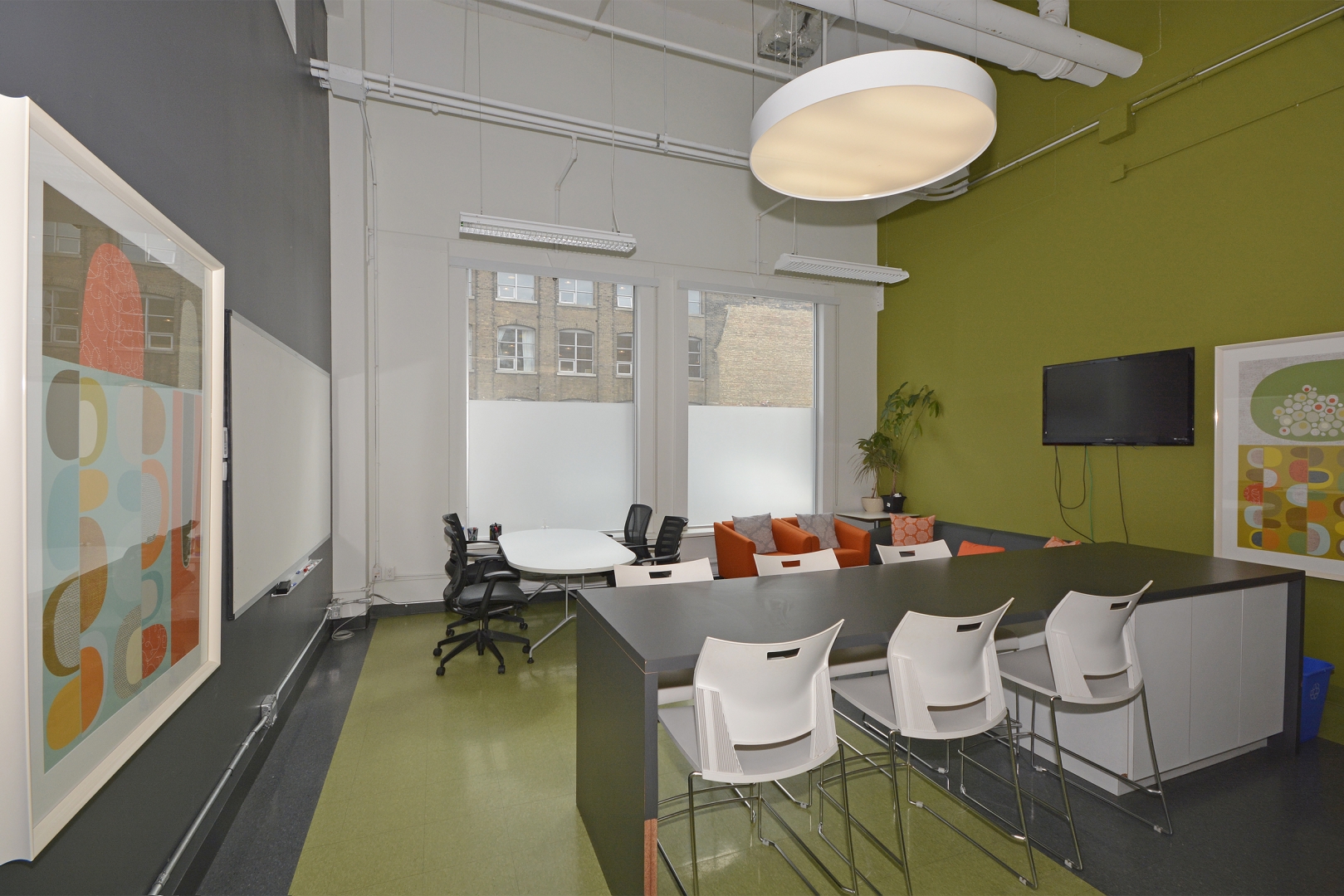 188 Spadina Avenue office with paintings and TV mounted on the wall