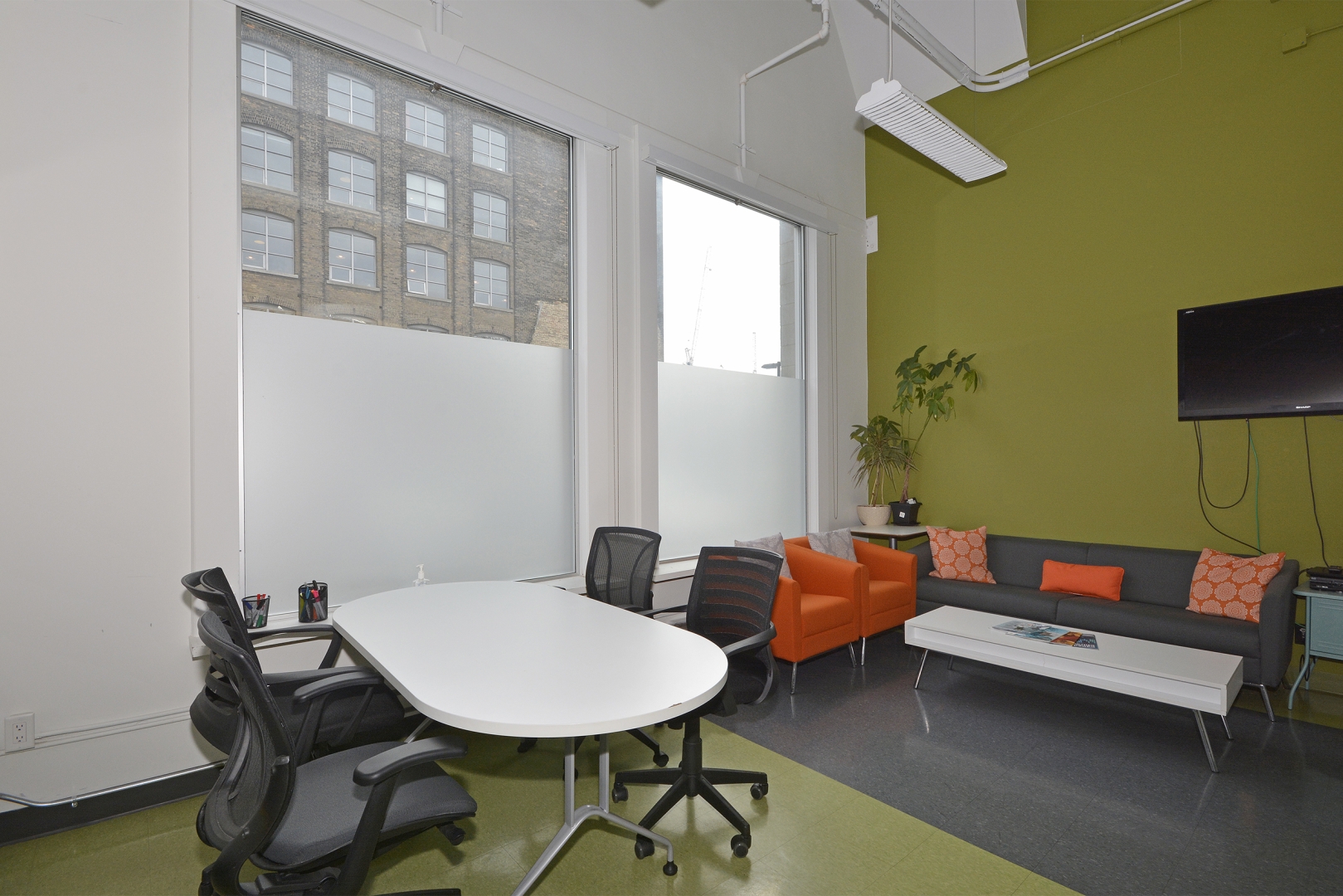 188 Spadina Avenue office space with TV overlooking the sofa and table