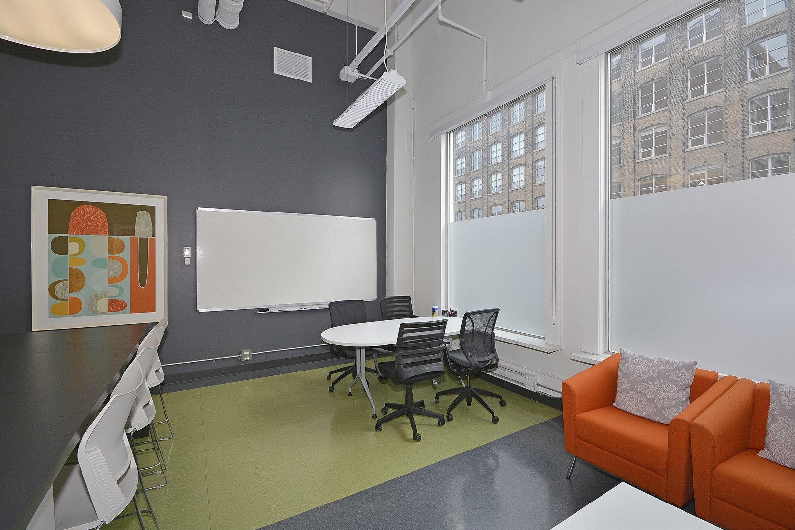 188 Spadina Avenue office space table and chairs beside the window and whiteboard on the wall