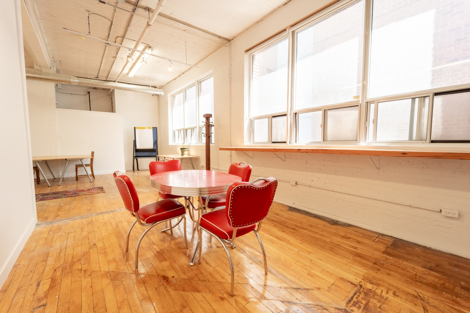 192 Spadina Avenue Fifth Floor private office with round table and red chairs