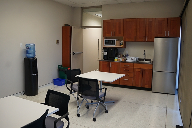 500 Parkdale Avenue N kitchen with desks and chairs and fridge