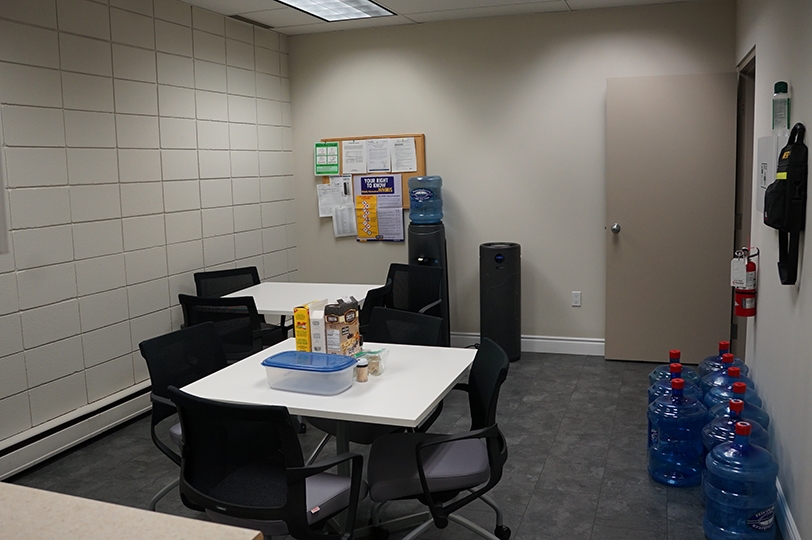 500 Parkdale Avenue N lunch room with white desks and black chairs