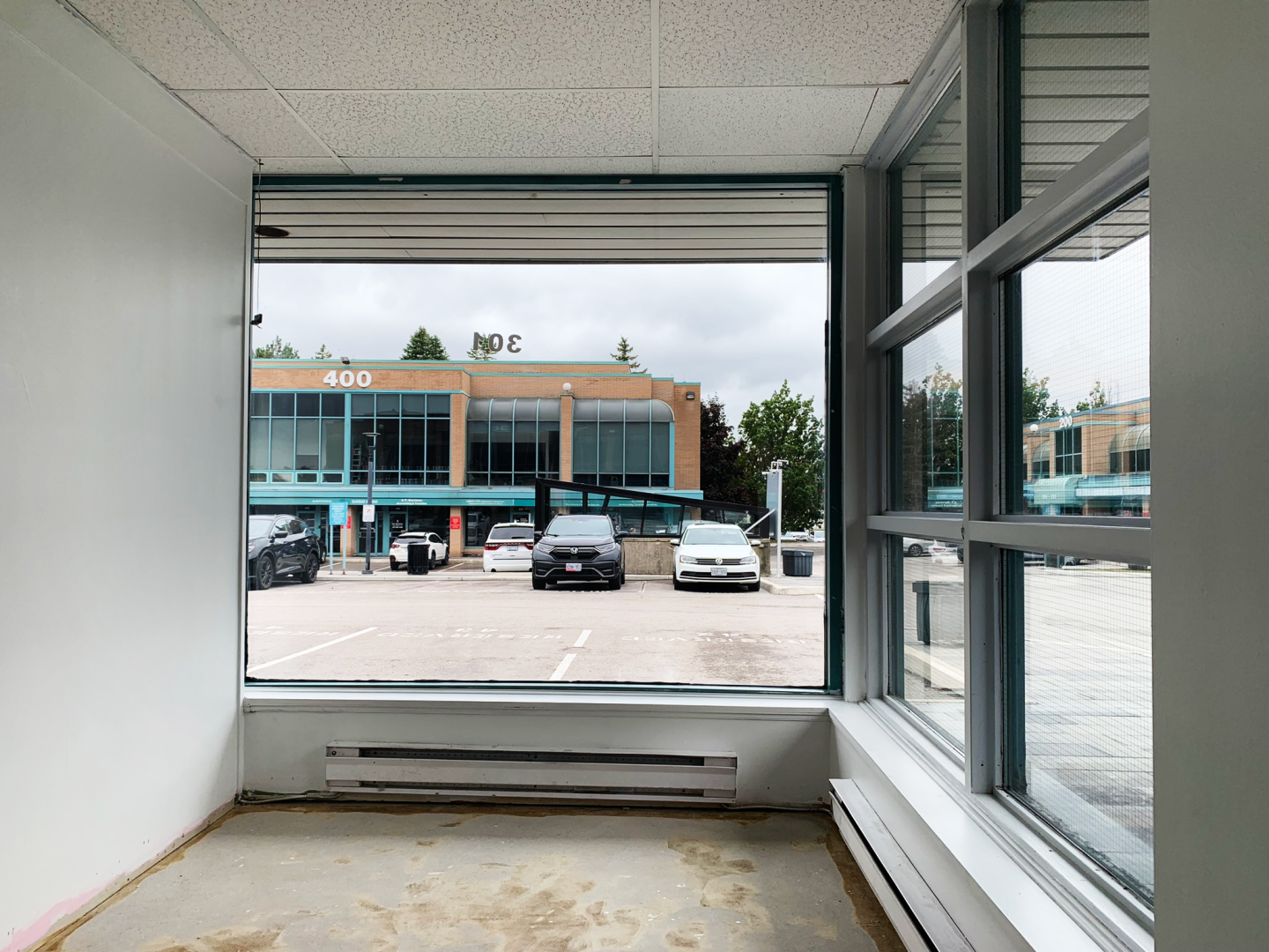  1315 Lawrence front windows showing parking area
