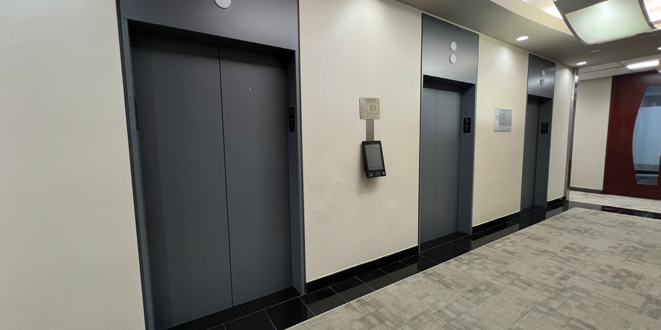 65 Queen Street West elevator lobby showing three elevators on one side