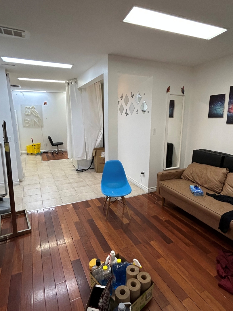 2350 Yonge Street open space with a mirror overlooking the sofa and chair