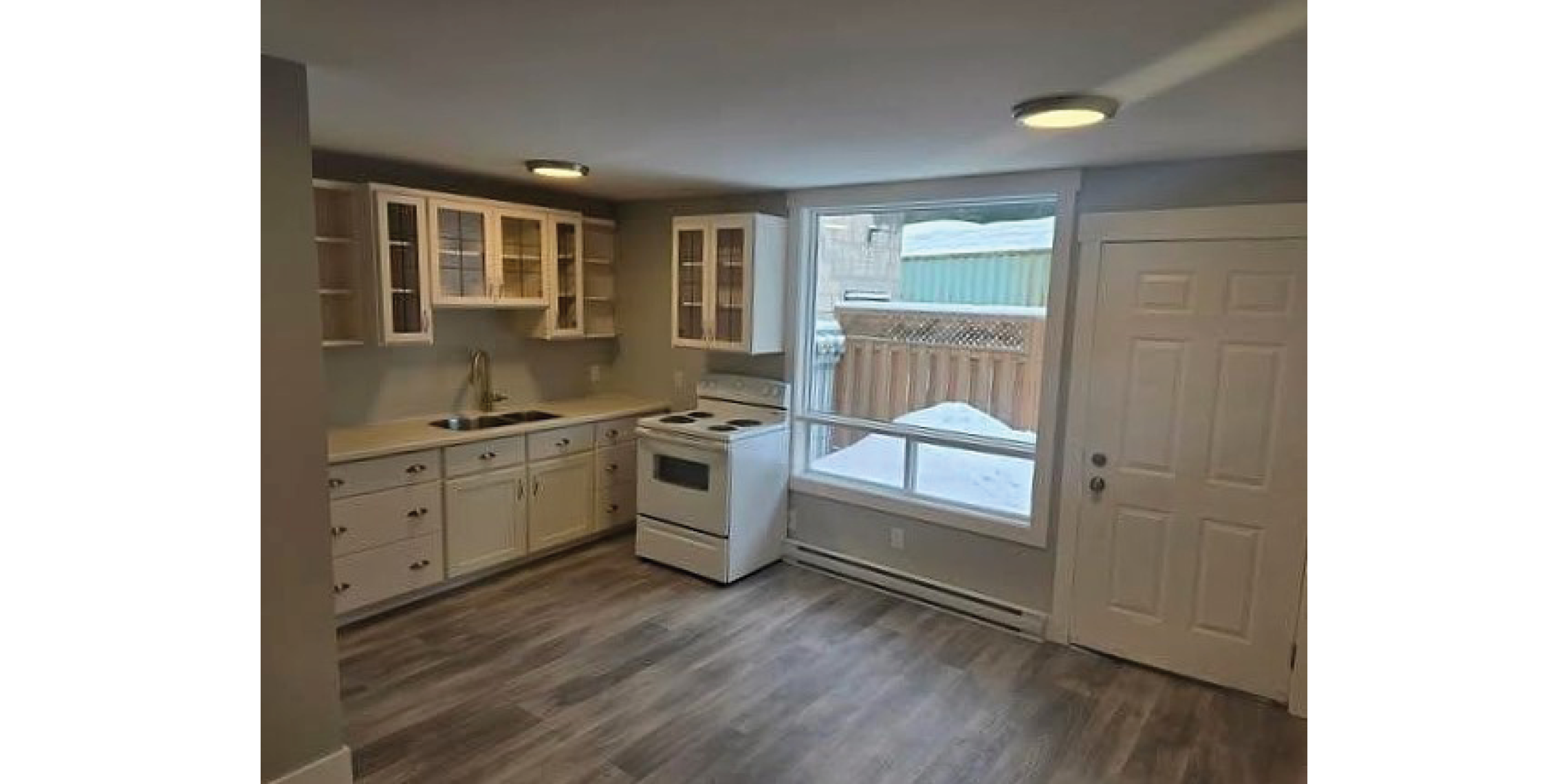310 Taylor Road Interior Kitchen with cupboards space, stove, sink and window