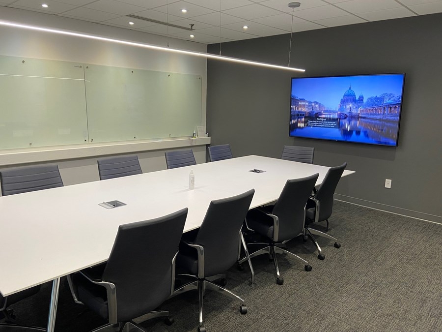 160 Pears Avenue boardroom with desk & chairs and TV mounted on the wall