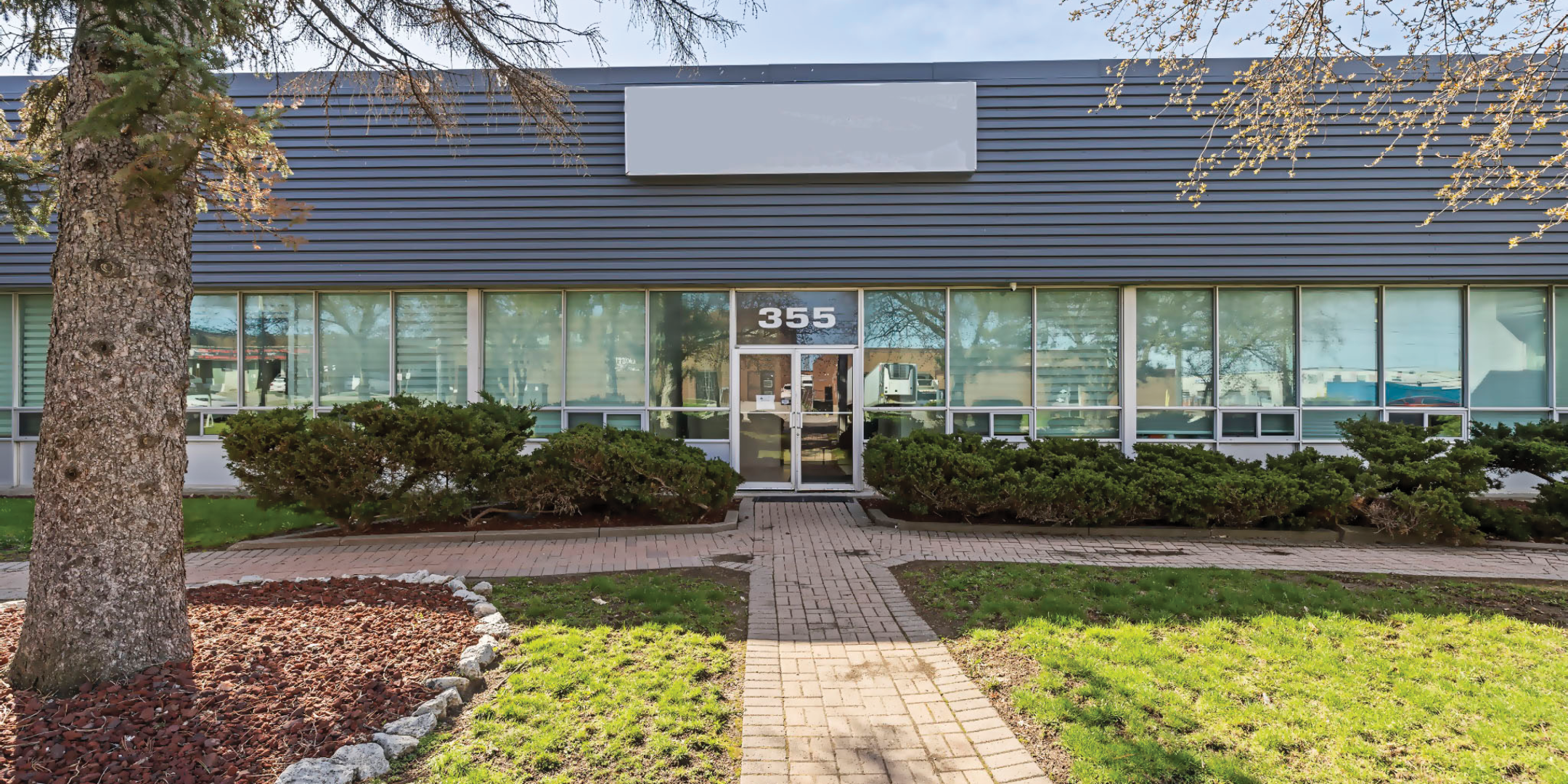 355 Garyray Drive Front of Building with glass front doors and lots of windows