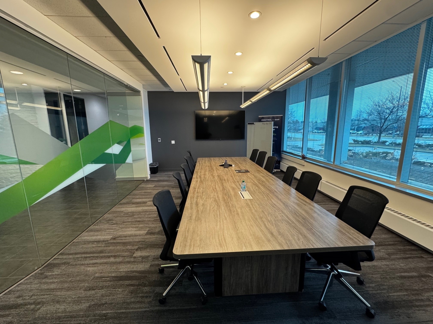 2680 Matheson Blvd E boardroom with a TV overlooking the desk and chairs
