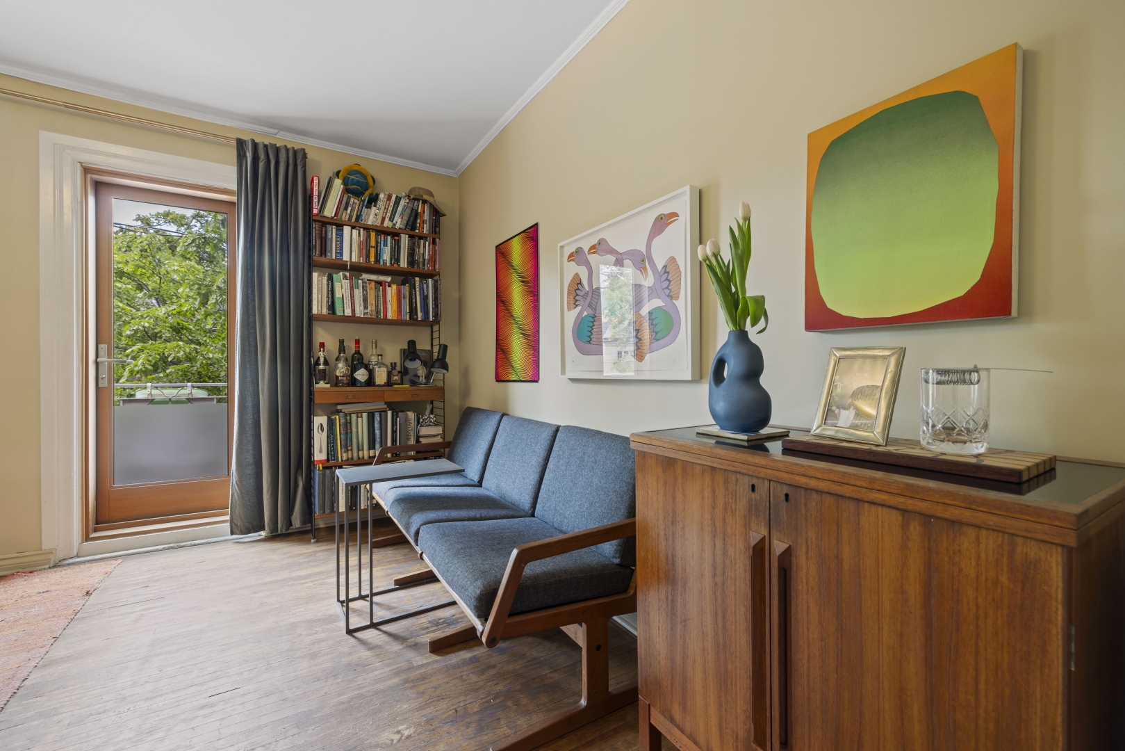 1157 Davenport Road 2nd floor living area with a bookshelf and window overlooking the sofas and table