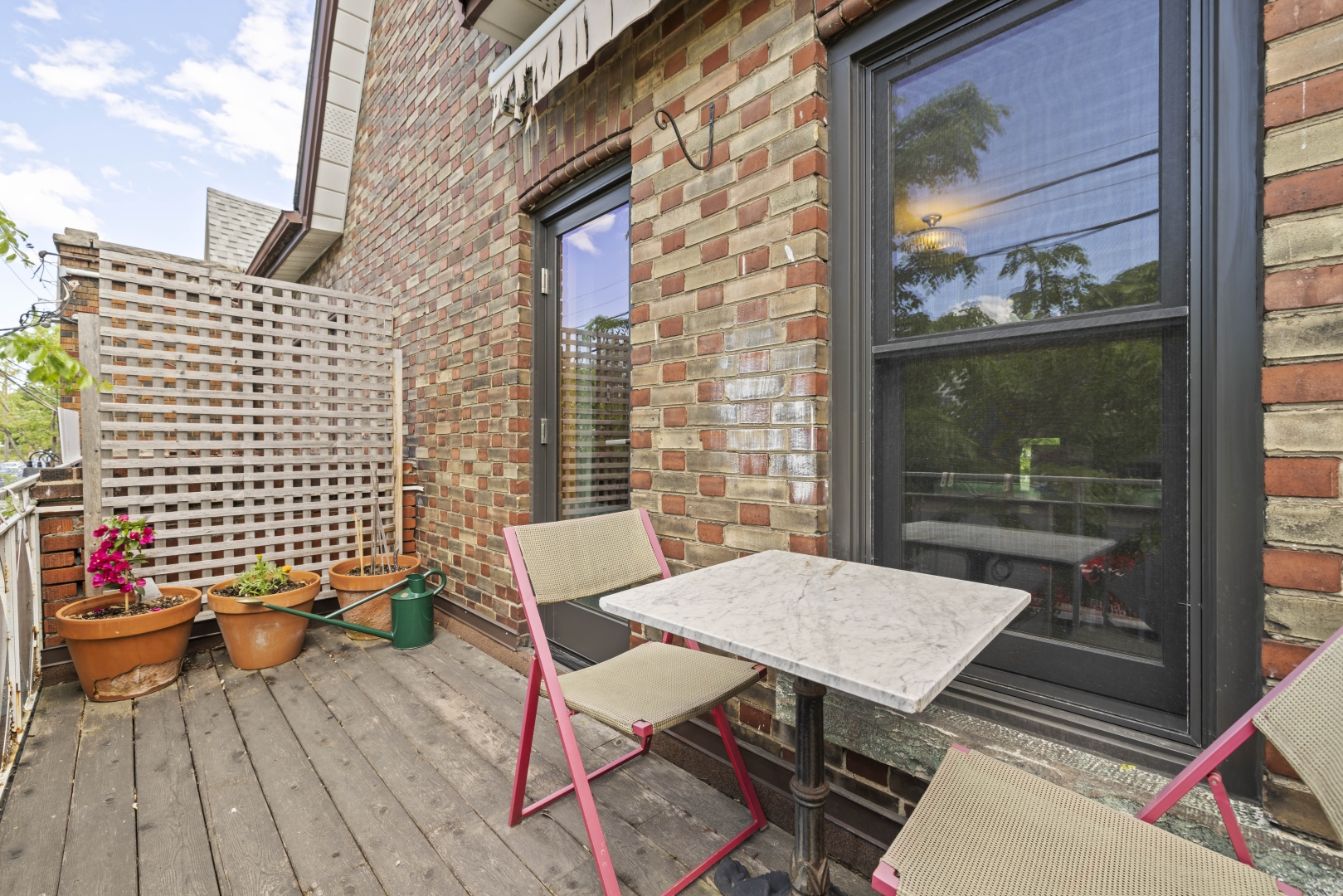 1157 Davenport Road backyard with fence, plants, a small table and chairs