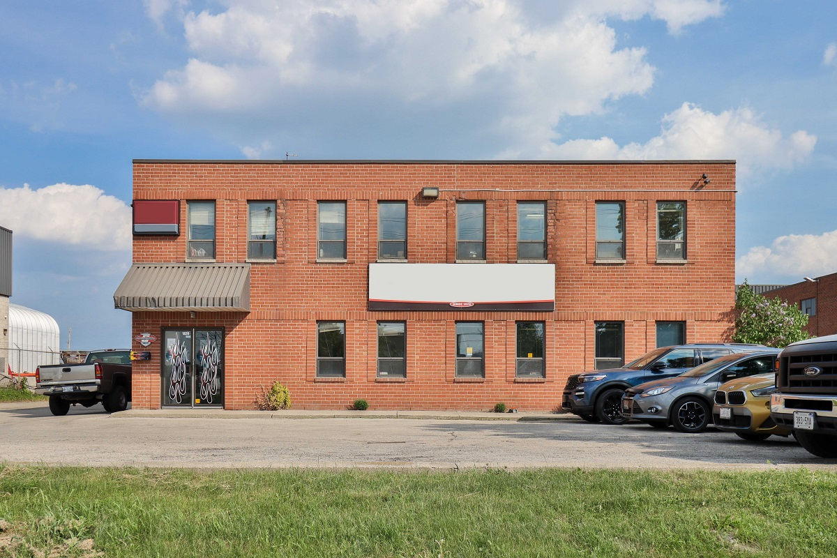 1828 Drew Road front exterior view of two storey brick building with windows and parking lot in front 