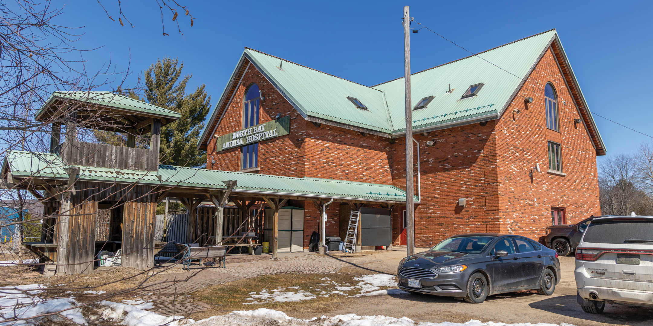 Side of Red Brick Farmhouse with parking
