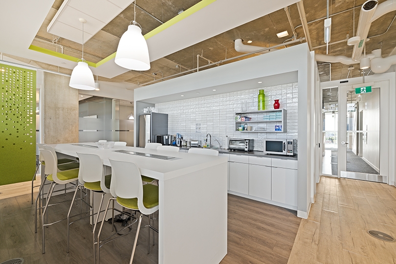 5015 Spectrum Way interior view of kitchenette features bar-height seating with green chairs