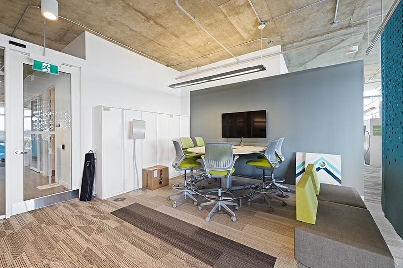 5015 Spectrum Way interior view of casual huddle area with high chairs and monitor