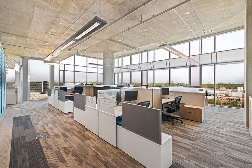 5015 Spectrum Way interior view of open office area with individual workstations along full-height windows