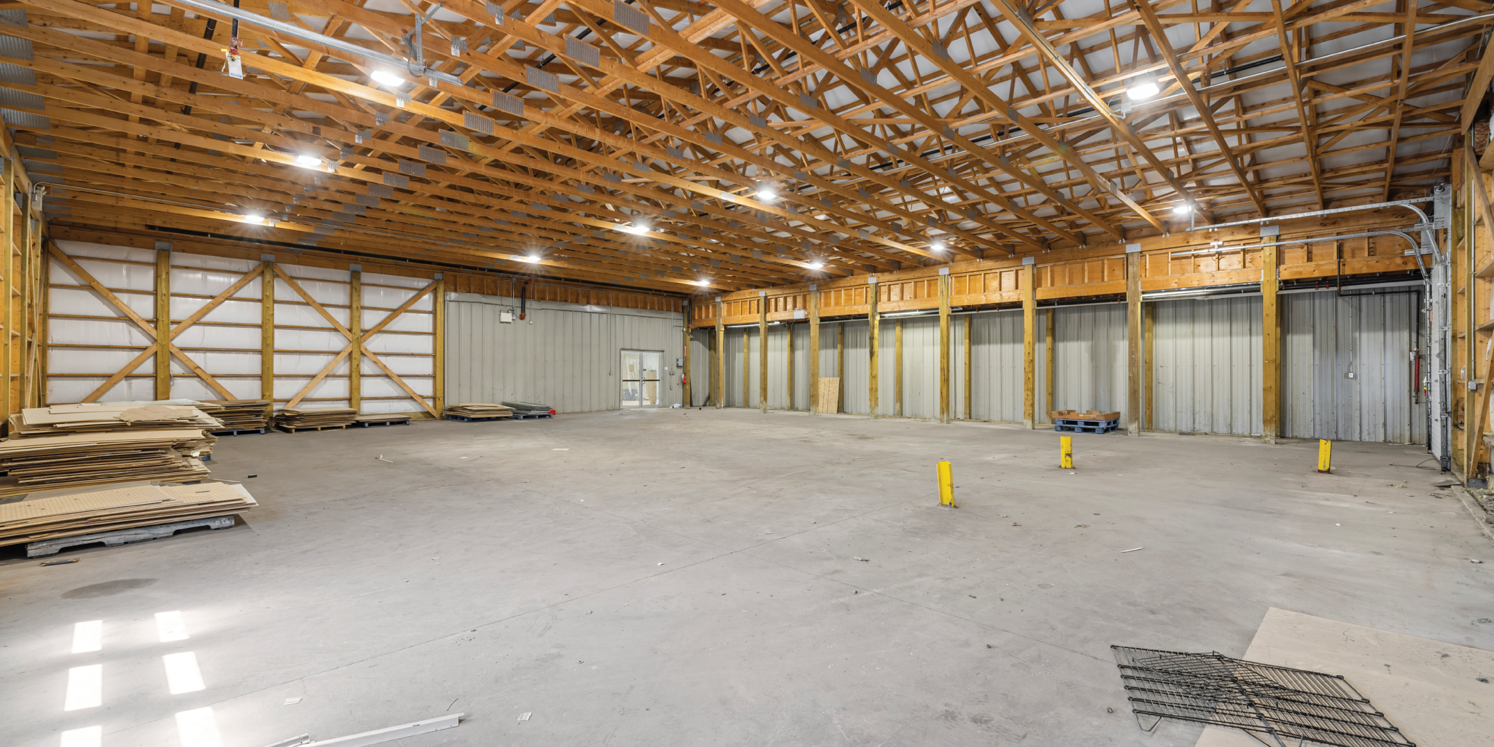 787 St. Clair Street, Chatham - Interior Warehouse Area with concrete flooringbright lights and wooden pillars on ceiling