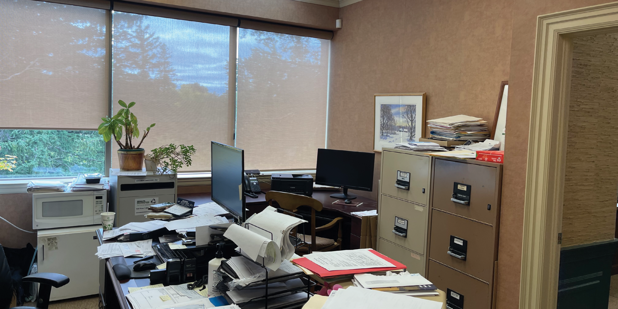 8312 McCowan Road Office with large windows, file cabinet, office chair and large desk