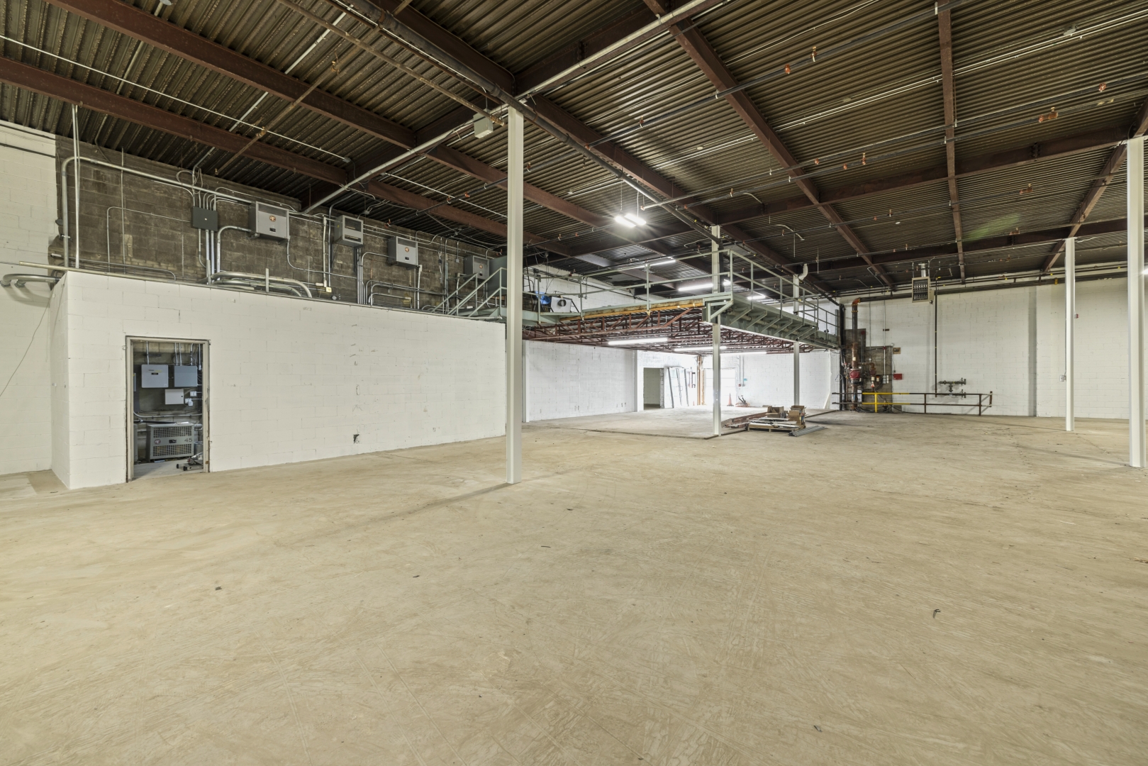 2562 Stanfield Road inside warehouse looking at mezzanine and door to electrical room