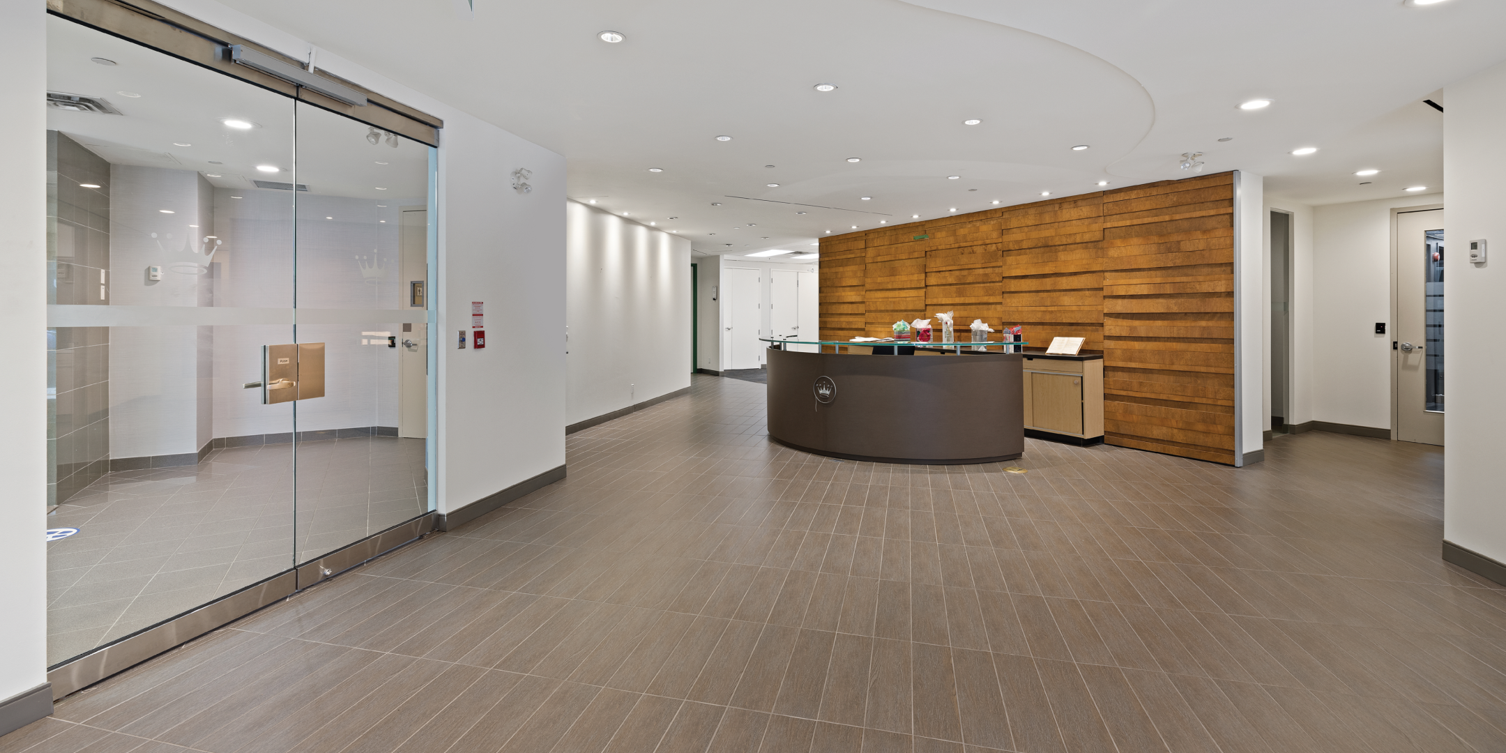 Lobby Entrance with reception desk and wooden tile wall