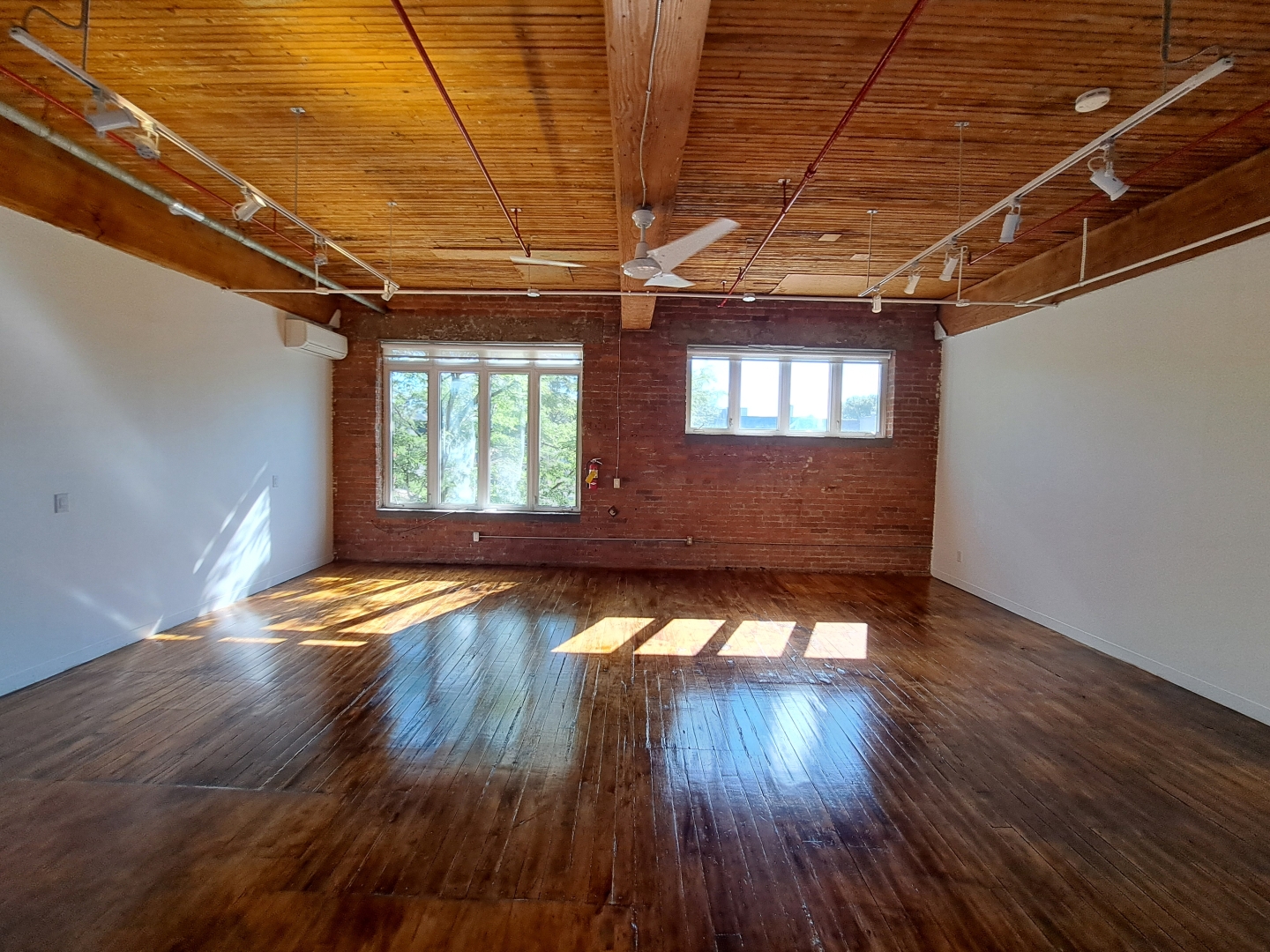77 Florence Street Suite 202 unfurnished space with several windows and fan