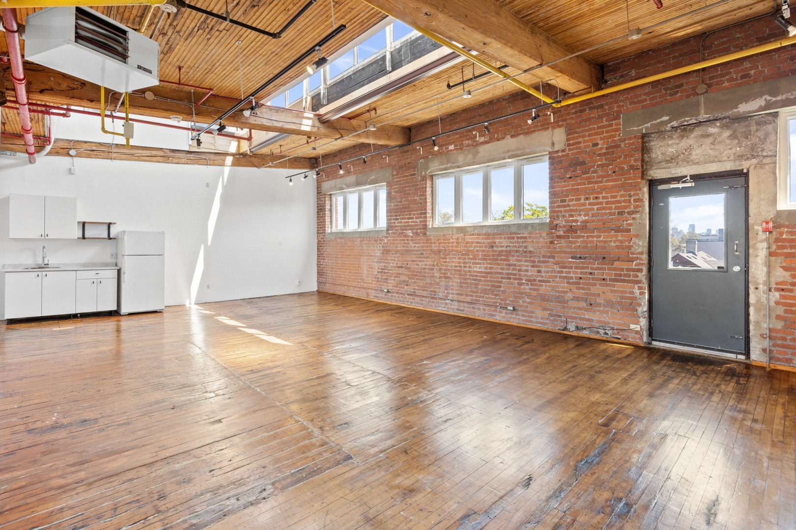 77 Florence Street Suite 304 unfurnished open space with windows, door, and cabinet
