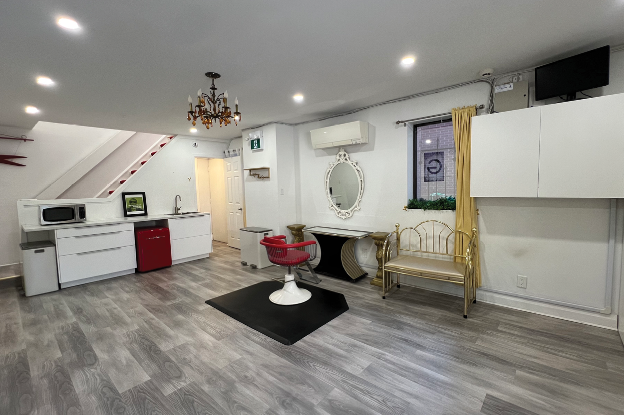 17 Stephanie Street salon mirror and seating area near window and kitchen.