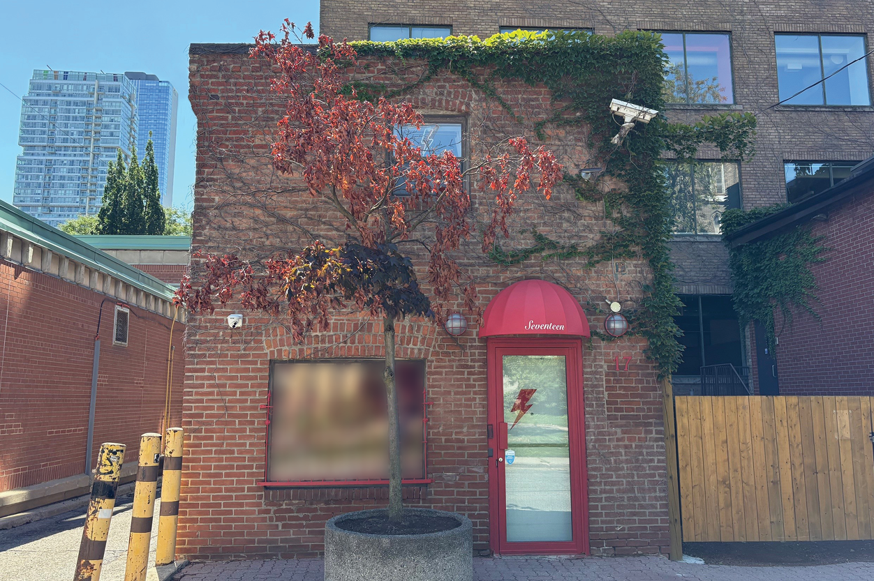 17 Stephanie Street brick building exterior with red door and “Seventeen” awning
