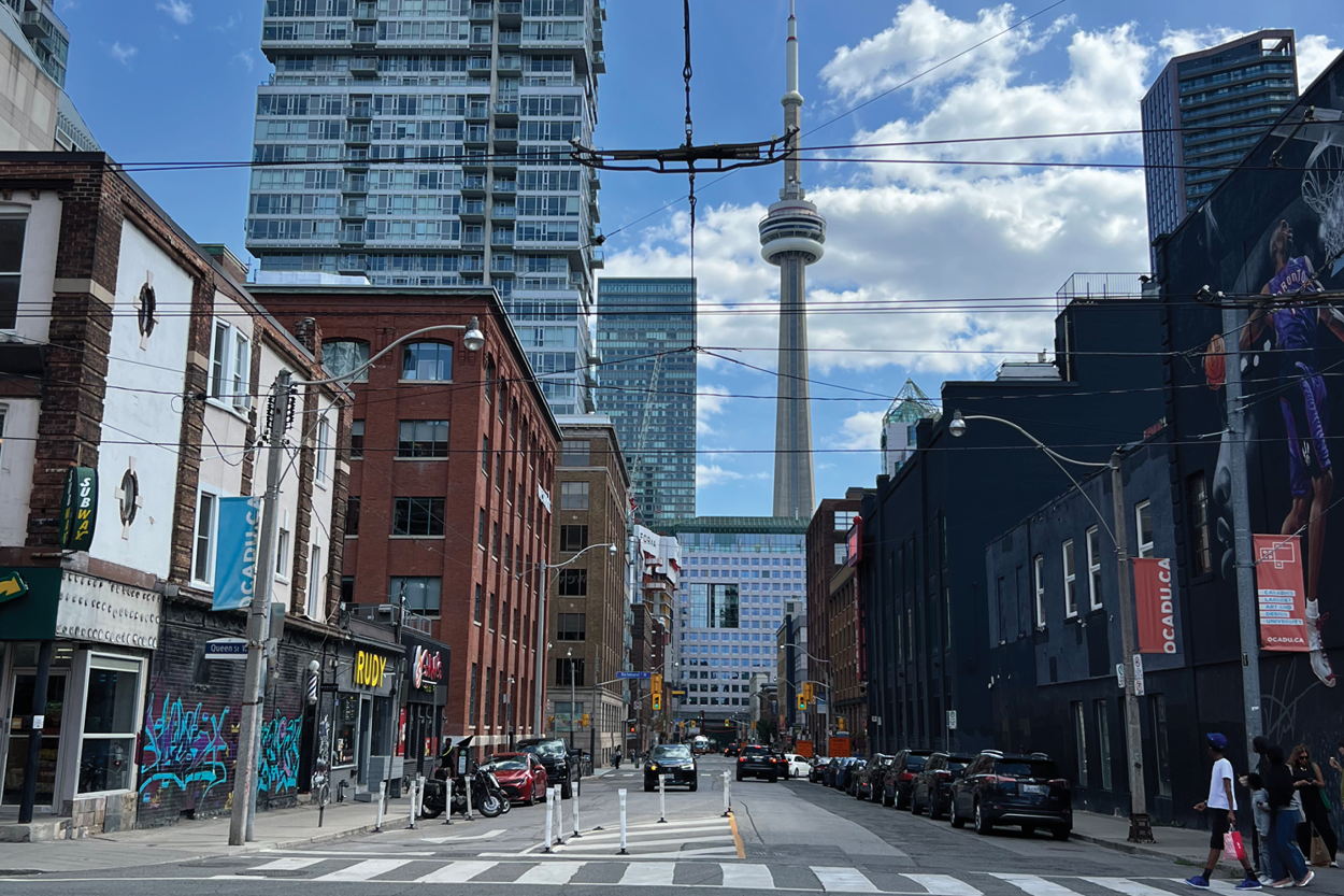 191 John Street street view of Queen Street West with the CN Tower in the background