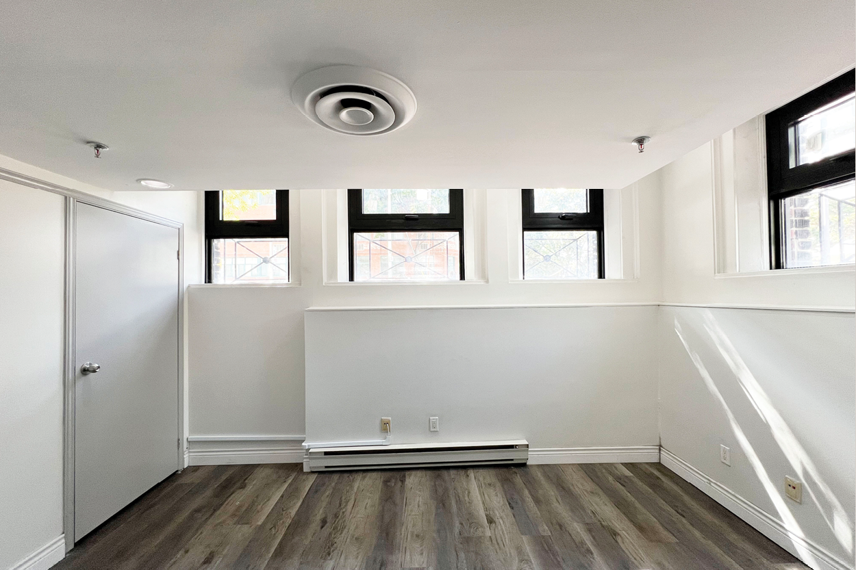191 John Street room with three upper windows and wood flooring