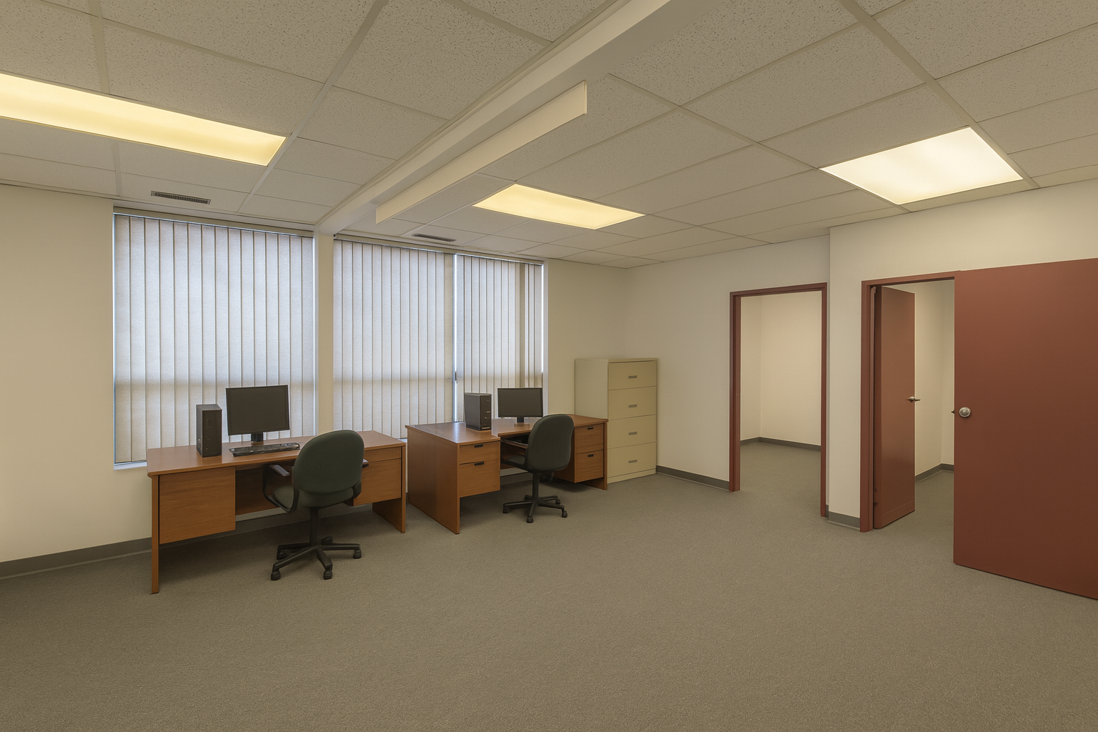 225 Nugget Avenue interior office with carpet floors, white painted walls, two windows, and two desks 