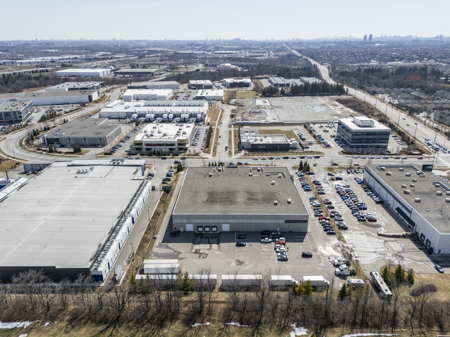 30 Via Renzo Drive aerial photo of building and surrounding area with parking and outdoor storage at the back of building