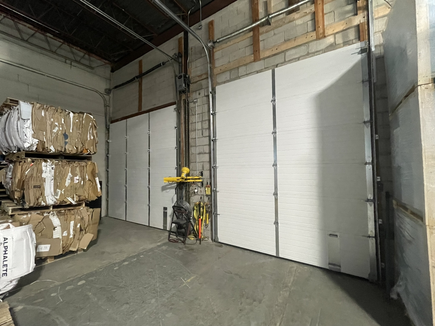 48-54 Carnforth Rd interior view of two Warehouse shipping doors with concrete flooring 