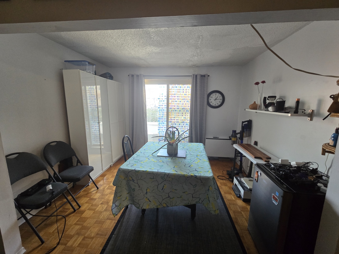 58-60 Kensington Avenue Unit 203 dining room with table and chairs and a small firdge on the side