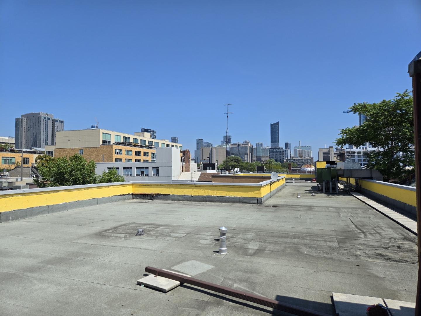 58-60 Kensington Avenue newly painted rooftop with a view of downtown Toronto