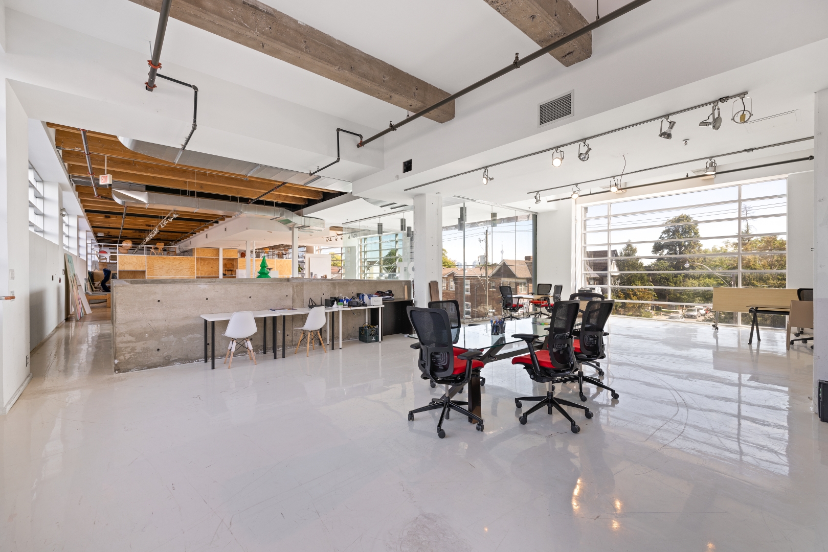 950 Dupont Street Open Space with a big window overlookding the desk and chairs
