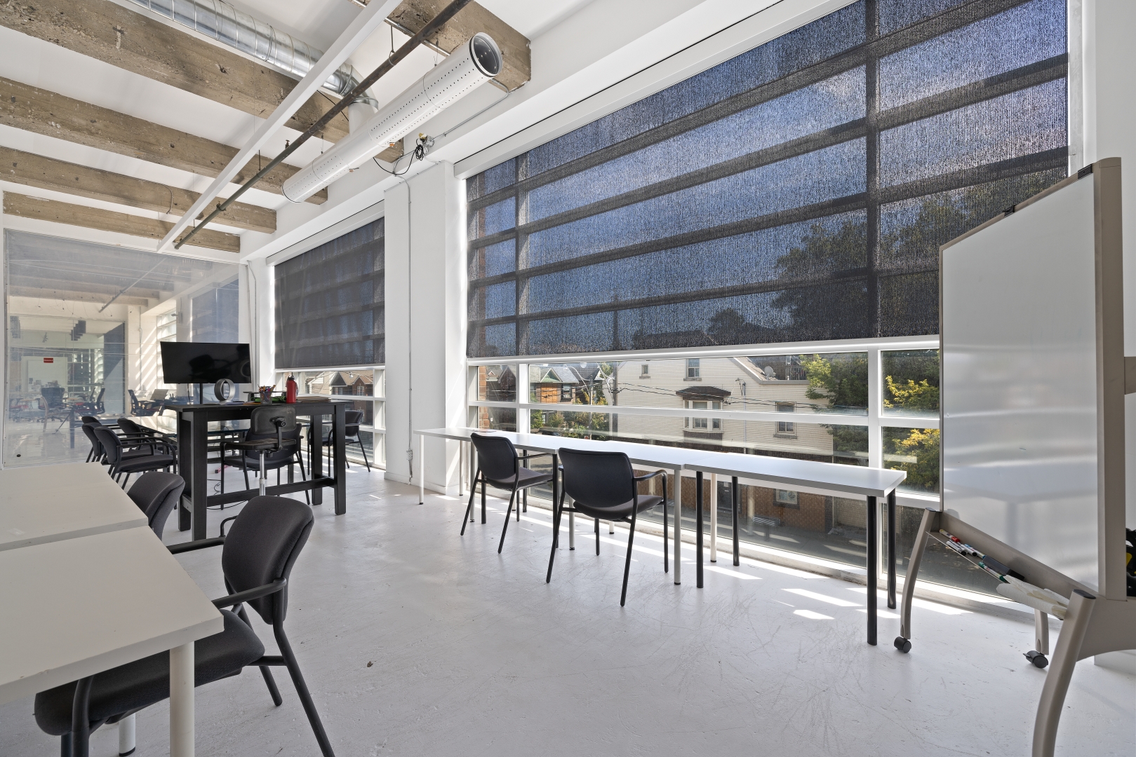 950 Dupont Street working spaces with white board beside the window and standing desks