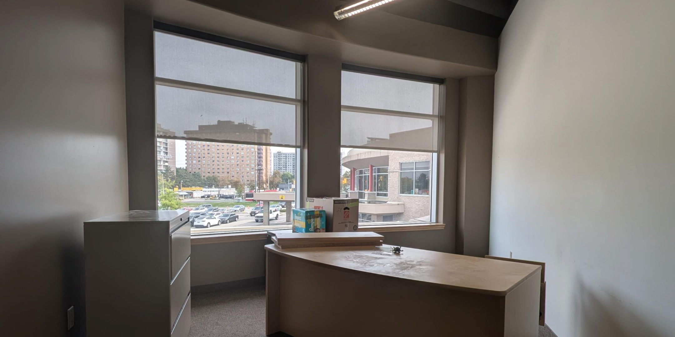 1250 Markham Road Office with two large windows and desk